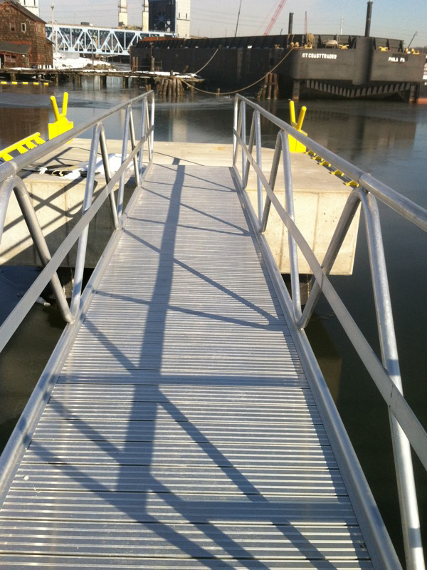 Aluminum gangway to dolphin to which barge is tied.