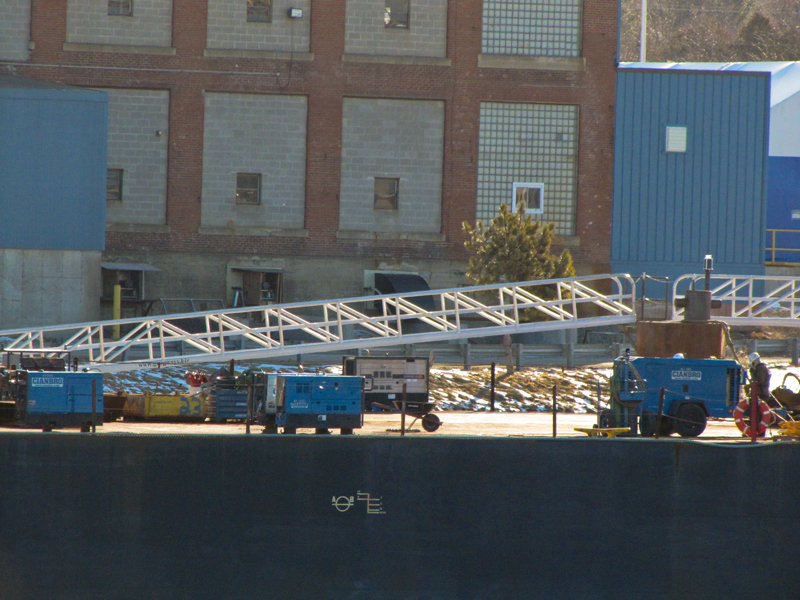 Aluminum gangway to dolphin to which barge is tied.