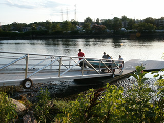 Rolling the aluminum skiff up the gangway.