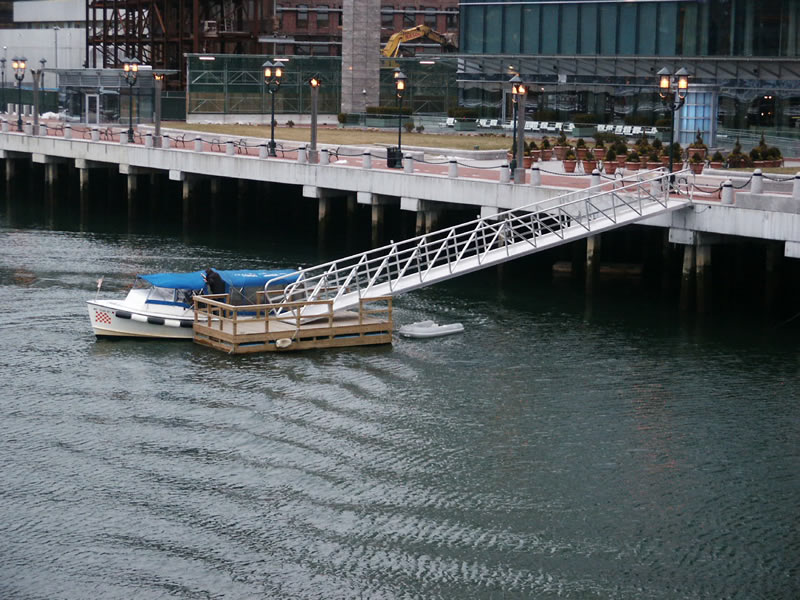 Water taxi picking up hotel guest on the way to Logan Airport.